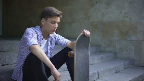 Sad Lonely Skater Sitting Alone With Skateboard, Bullying Problem, Teenager