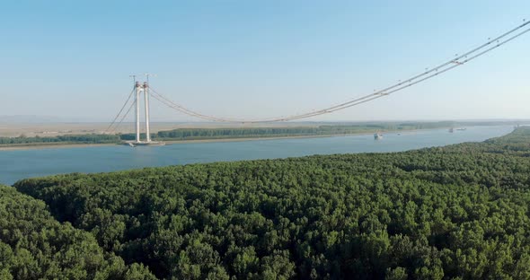 Approaching Ships Across Danube River With Braila-Tulcea New Bridge In Eastern Romania