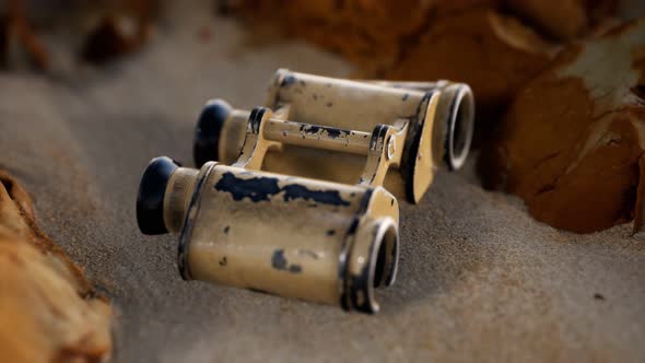 Old German Military Binoculars on the Sand Beach alt