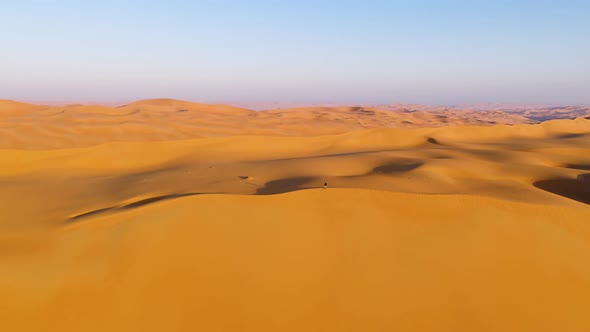 Aerial view of a man standing on the edge of dunes, U.A.E.