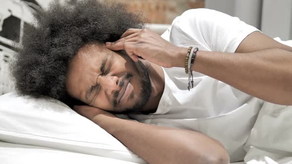 Headache Sleeping African Man with Head Pain