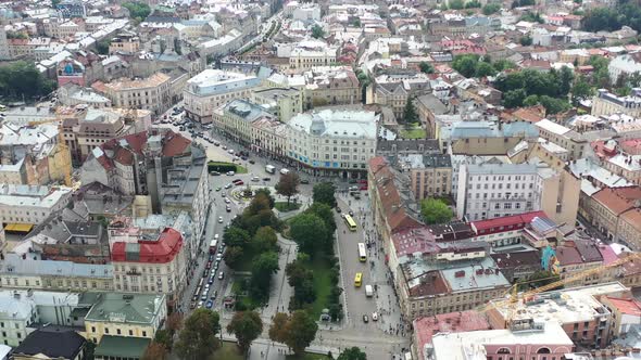 Park in downtown Lviv Ukraine overlooking old historical European city buildings with cars driving a