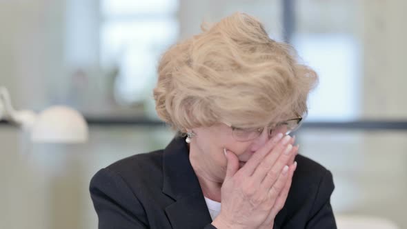 Portrait of Old Businesswoman Sneezing