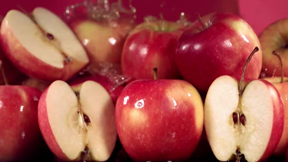 Slow Motion Shot of Red Apple Juice Splashing Through Apple Slices