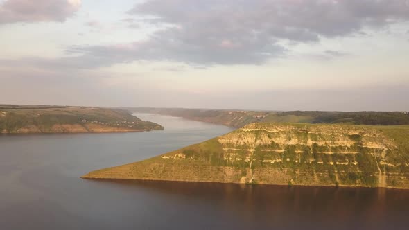 Aerial view of wide Dnister river and distant rocky hills in Bakota area, part of the National park 