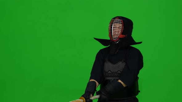 Masculine Kendo Warrior Practicing Martial Art with the Bamboo Bokken on Green Screen. CLose Up