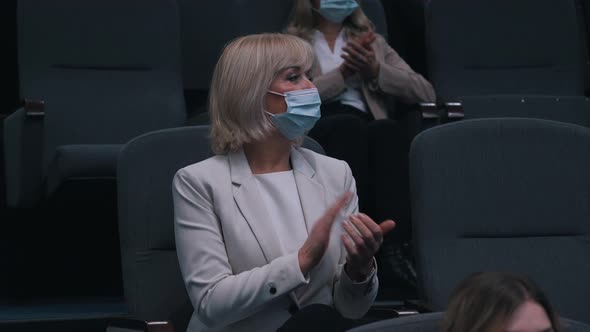 Women Applaud the Speaker at the Conference