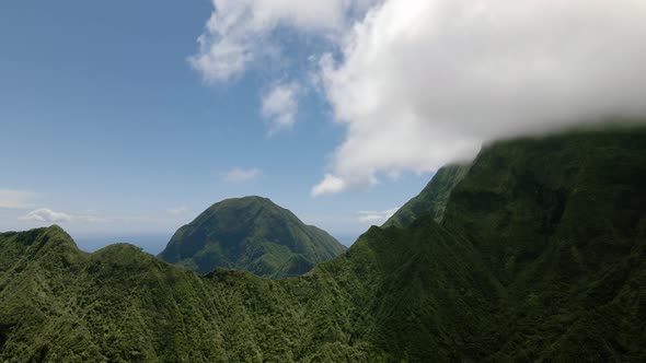 Drone footage of Maui highlands, mountains covered with dense rainforest, Hawaii