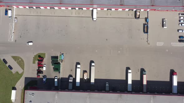 Aerial view of the logistics warehouse with trucks waiting for loading