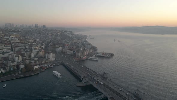 Aerial shot of Galata Bridge and Golden horn at sunrise