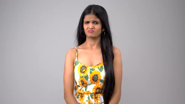 Disgusted Indian girl observing someone