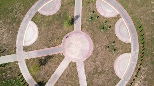 Top view of a bicycle woman riding a bicycle on a circular road in a city park.