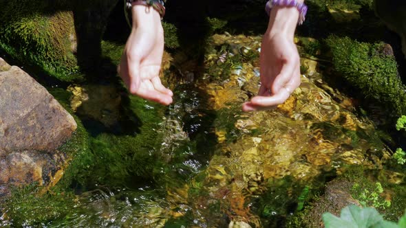 Female Hands Scoop Up Clear Water From Stream