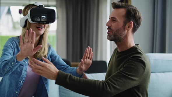 Modern couple using virtual reality simulator
