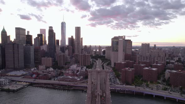 Aerial view of traffic on the Brooklyn bridge and high-rise in Lower Manhattan, sunset in NY, USA