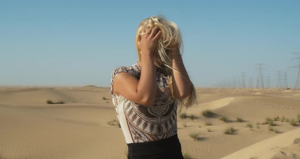 Blonde Hair of a Young Woman is Flailing in the Wind of Great Sandy Desert