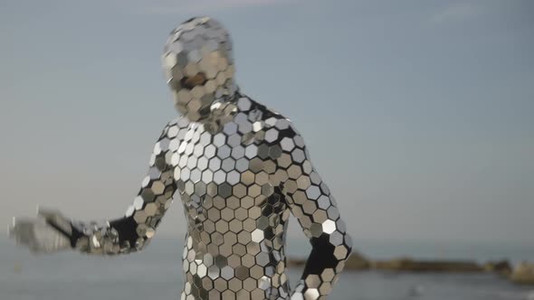 Sparkling Discosuit Man Dancing Next to the Sea