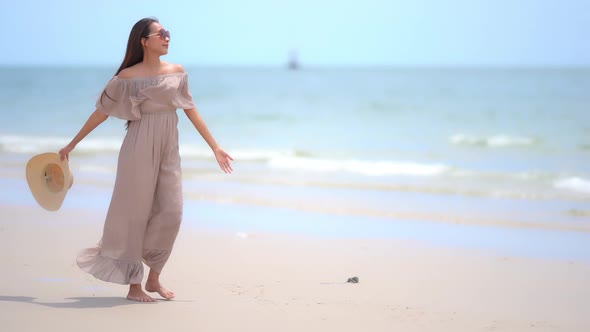 Asian woman enjoy around beautiful beach sea ocean