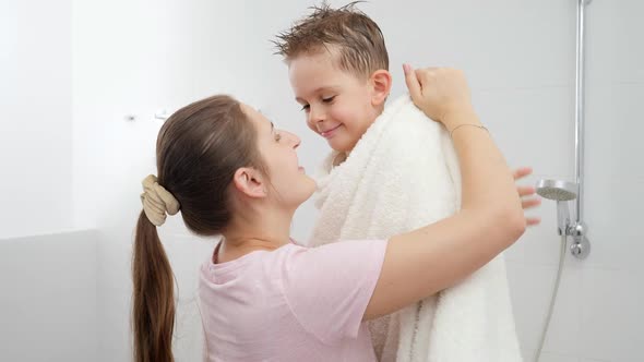 Caring Mother Drying Her Son with Towel and Hugging After Bathing