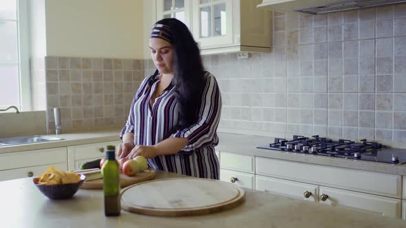 Plump Girl Is Cooking in the Kitchen