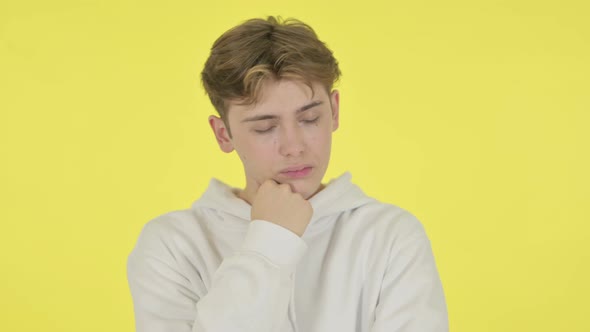 Young Man Sleeping on Yellow Background