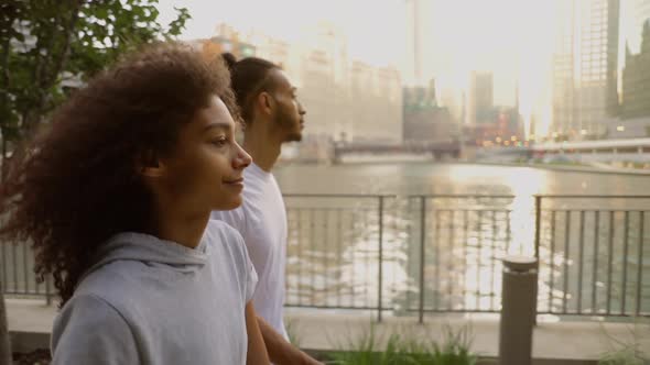 Cute African American couple walk together along the Chicago River