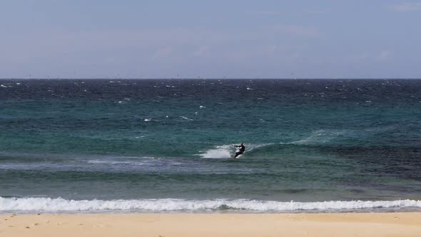 high frame rate clip of a a kiteboarder riding waves