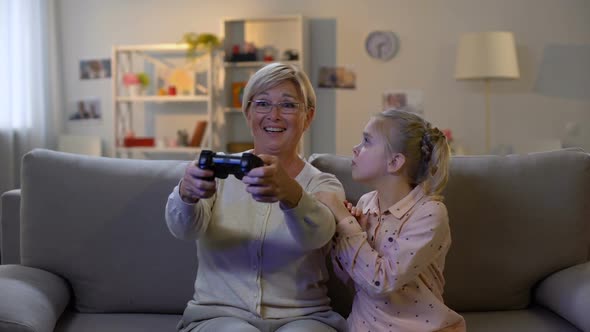 Upset Granddaughter Taking Game Joystick From Granny Hands, Misunderstanding