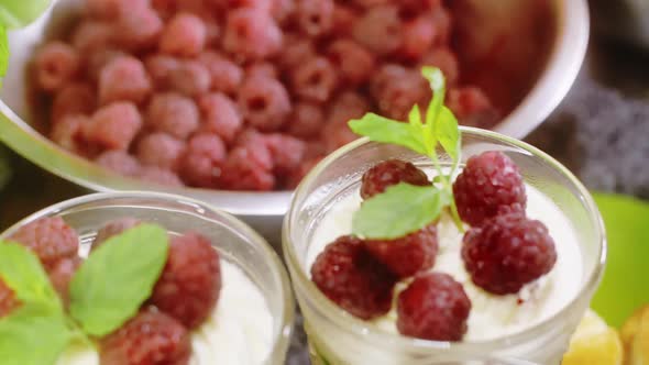 Bowl with fresh raspberries and desserts with raspberries
