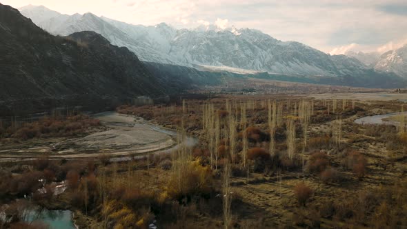 Aerial Flying Over Sweeping Landscape Of Ghizer Valley Of Gilgit Baltistan With Snow Capped Mountain