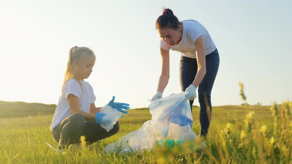 Mom and Daughter Cleaning Plastic Waste