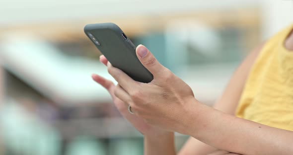 Woman use of mobile phone in shopping mall