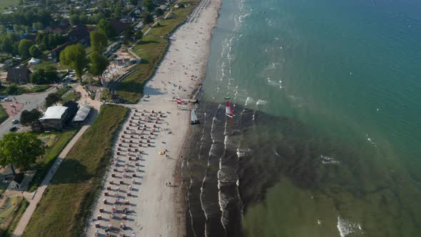 Aerial Drone View of Two Sailboats in Tourist Beach at Baltic Sea Coastline Scharbeutz Germany