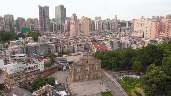Aerial view flying forward over Ruins of Saint Paul's to reveal Macau cityscape