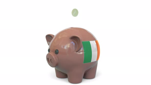 Putting Money Into Piggy Bank with Flag of the Republic of Ireland