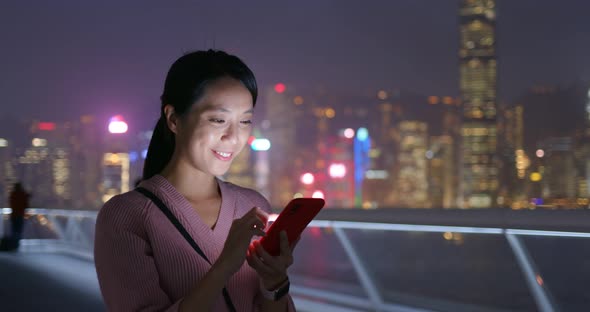 Woman use of mobile phone at night