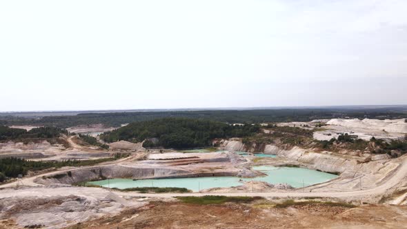 Aerial view quarry extraction porcelain clay, kaolin, with turquoise water