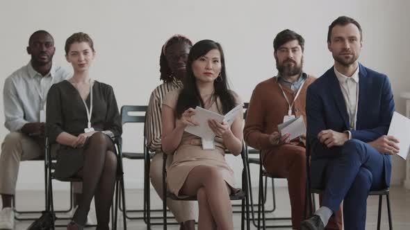 Multiethnic Business Men and Women Sitting