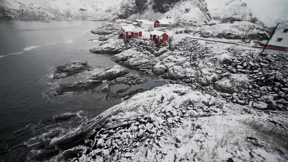 Hiker In Ice And Snow By Hamnoy Village