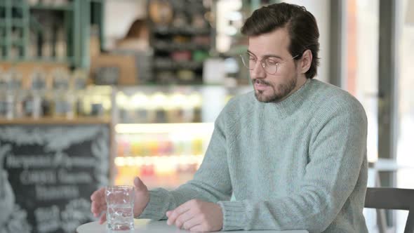 Attractive Young Man Drinking Water Cafe