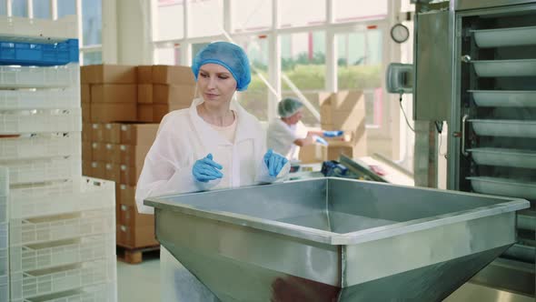 Factory Worker Checking Packing Machine