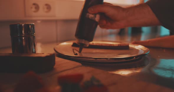 A professional chef is plating with fresh chocolate