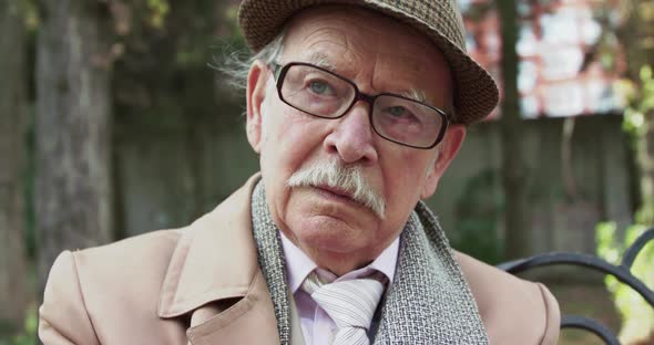 Portrait of Lonely Thoughtful Senior Man Looks at Point While Resting on Bench