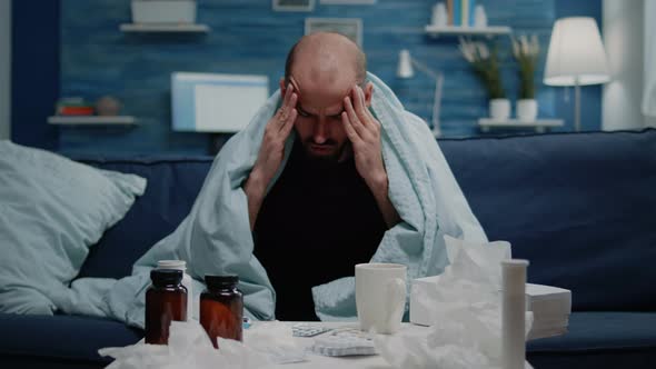 Close Up of Sick Adult with Headache Rubbing Temples