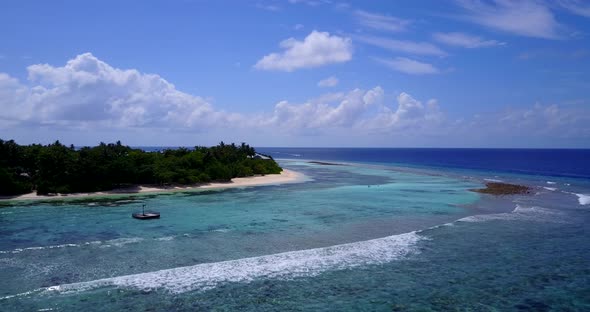 Tropical flying travel shot of a paradise sunny white sand beach and blue ocean background