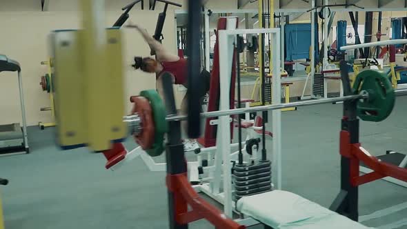 Young Athletic Girl Athletic Build Runs Along the Gym Performing Acrobatic Stunts