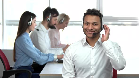 Cheerful Indian Call Center Operator Saying Yes, Windows Background.