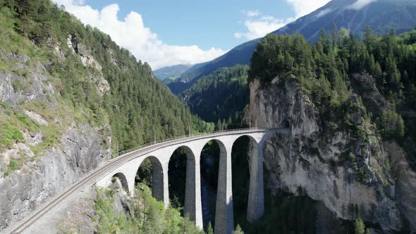 Landwasser Viaduct in Swiss Alps in Summer Aerial View on Green Mountain Valley