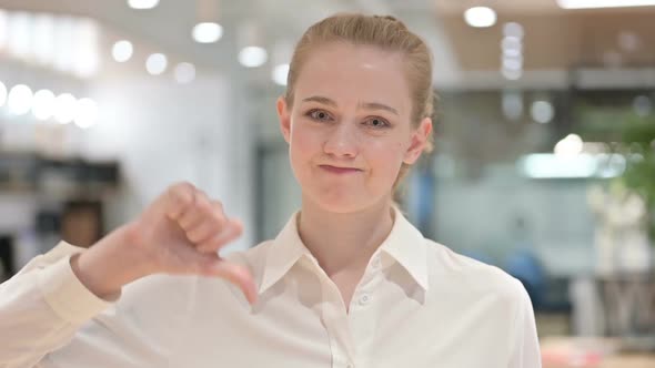 Portrait of Disappointed Businesswoman Doing Thumbs Down Sign