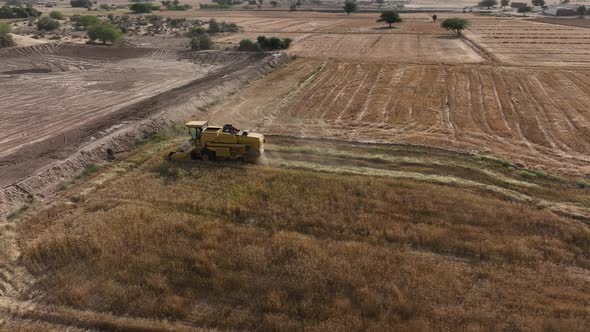 Aerial View Of Combine Harvester Working In Punjab Field In Pakistan